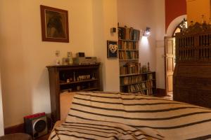a bedroom with a bed and a book shelf at Almawasi Lodge in Yungay
