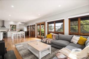 a living room with a couch and a table at Strong Farmers Cottage Willunga in Willunga