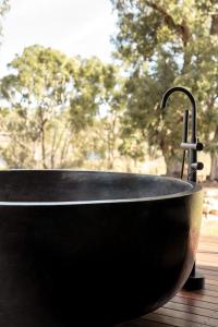 a black bath tub with a water faucet at Serenità Stanthorpe in Severnlea