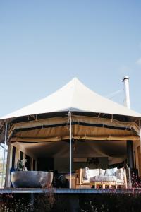 a large tent with a table and a tub at Serenità Stanthorpe in Severnlea