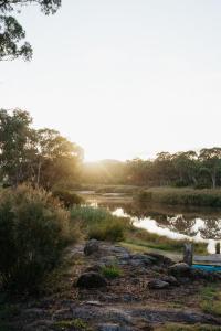 a view of a river with the sun setting at Serenità Stanthorpe in Severnlea