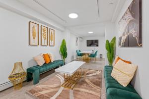 sala de estar con sofás verdes y mesa en Upper East Side Luxury 3BR 2B en Nueva York