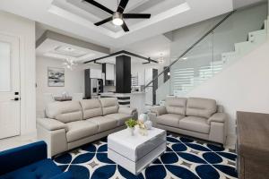 a living room with two couches and a table at Quinta Real 4909 in McAllen