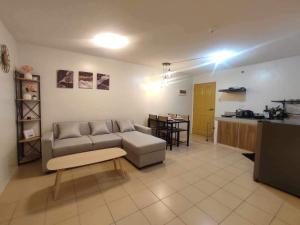 a living room with a couch and a table at One Spatial Condo in Iloilo City