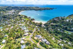 an aerial view of a beach with houses and the ocean at Little Ocean Hideaway in Oneroa