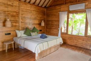 Ένα ή περισσότερα κρεβάτια σε δωμάτιο στο Kelapa Cabin