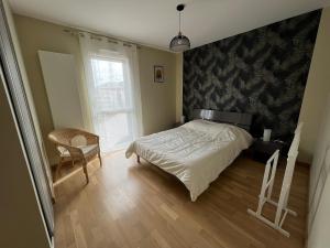 ein Schlafzimmer mit einem Bett, einem Stuhl und einem Fenster in der Unterkunft Appartement Les Sables-d'Olonne, 3 pièces, 4 personnes - FR-1-485-21 in Les Sables-dʼOlonne