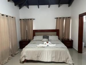 a bedroom with a bed with two stuffed animals on it at Rooftop Paradise in San Francisco de Macorís