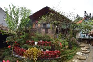 a garden with flowers and plants in front of a house at An's Space Sapa in Lao Cai