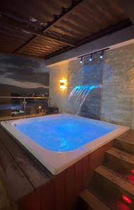 a large blue tub with a water fountain at Rooftop Paradise in San Francisco de Macorís
