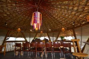 a dining room with a table and chairs and a chandelier at An's Space Sapa in Lao Cai