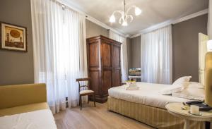 Postel nebo postele na pokoji v ubytování A Palazzo Busdraghi Residenza D'Epoca