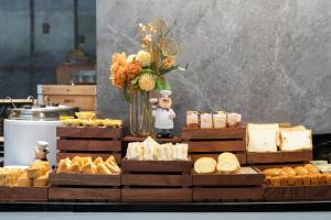 a display of different types of cheese and pastries at Elephant Hotel in Zhuhai