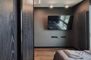 a bedroom with a flat screen tv on the wall at Oceanview Apartment baltyk Gdynia in Gdynia