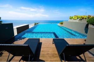 a swimming pool with a view of the ocean at C sky Seaview @The Blu X in Bangsaen