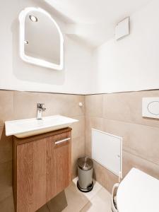 a bathroom with a sink and a toilet at Reihenendhaus Marina Sol in Dahme