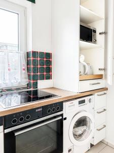 a kitchen with a dishwasher and a washer and dryer at Reihenendhaus Marina Sol in Dahme