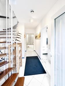 a hallway with stairs and a blue rug at Reihenendhaus Marina Sol in Dahme +13 photos