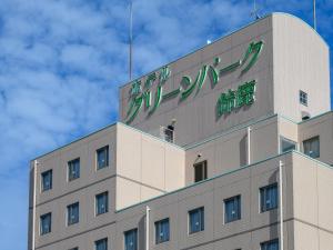 a building with a sign on the top of it at Hotel Green Park Suzuka in Suzuka