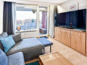 a living room with a couch and a large television at FeWo Ferienglück Berolina 131 in Dahme