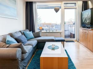 a living room with a couch and a coffee table at FeWo Ferienglück Berolina 131 in Dahme