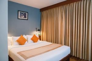 Postel nebo postele na pokoji v ubytování Pakse hotel & Restaurant
