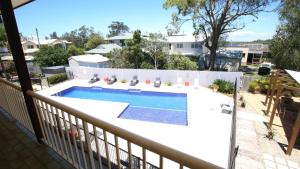 a swimming pool on the balcony of a house at Hawks Nest Motel in Hawks Nest