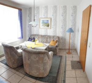a living room with a couch and a table and chairs at Ferienhof Manowski Nr2 in Hinrichsdorf
