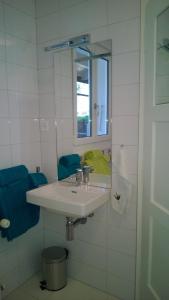 bagno bianco con lavandino e specchio di Swiss Borzoi House a Bellerive