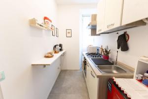 a small kitchen with a sink and a stove at Il Giglio - Free Parking in Como