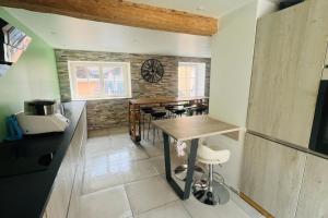 a kitchen with a table and chairs in a room at Maison de Renaud in Eguisheim