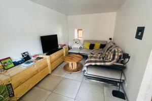 a living room with a couch and a table at Maison de Renaud in Eguisheim