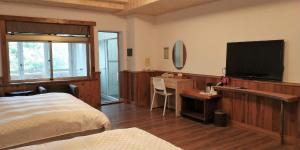 Letto o letti in una camera di Dragon Manor Resort