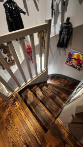 a wooden staircase in a room with costumes on the wall at maison 3 chambres avec piscine in Calvi