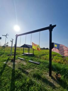 a swing with an american flag and an american flag at Panorama Indah Homestay in Sungai Besar
