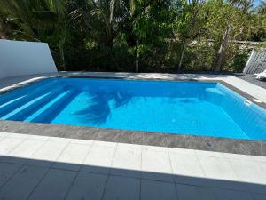 a small blue swimming pool in a yard at Pool villa copacolanta with 2 motorbikes for free in Ko Lanta