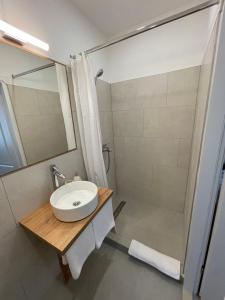 a bathroom with a sink and a shower at Aurelia Rooms in Mostar