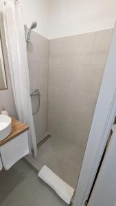 a bathroom with a shower and a sink at Aurelia Rooms in Mostar