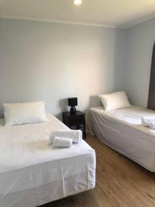 twee bedden naast elkaar in een kamer bij Family-Friendly 5-Bedroom Home Near Uni & Hamilton Gardens - Sleeps 10 in Hamilton