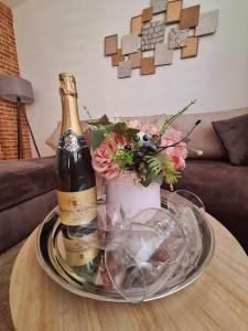 a bottle of champagne and flowers on a table at CENTAR in Brčko