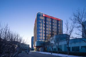 a tall building with red lights on top of it at Hilton Garden Inn Beijing Daxing Jinyuan Road in Beijing