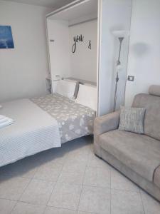 a living room with a bed and a couch at Appartamento Oxygen in Riva del Garda