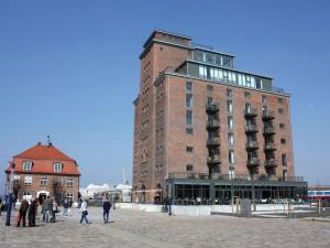 a tall brick building with people walking in front of it at Old town view in the Ohlerich warehouse in Wismar