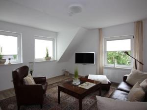 a living room with a couch and a table at Gerda in the Michaela House in Borkum