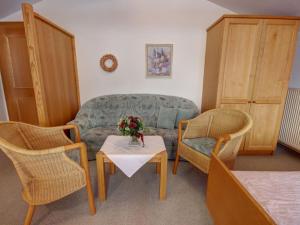 a living room with a couch and two chairs and a table at Kienberg Comfortable holiday residence in Inzell