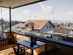 a balcony with a table and chairs and a view at Holiday apartment 3 in the holiday home Sandra in Hörbranz