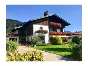 a house with flower boxes on the front of it at Kienberg Comfortable holiday residence in Inzell