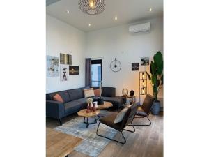 sala de estar con sofá y sillas en Cube Elite Noteboom 11, en Hulshorst