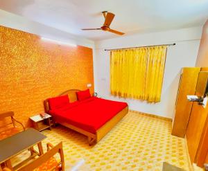 a bedroom with a red bed and a yellow wall at Grand view lodge and Restaurant Dharamshala - Partial Prepayment required to confirm booking in Dharamshala