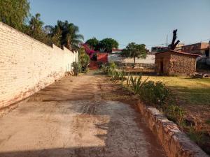 an empty dirt road next to a brick wall at VILLA ESCONDIDA in San Juan del Río